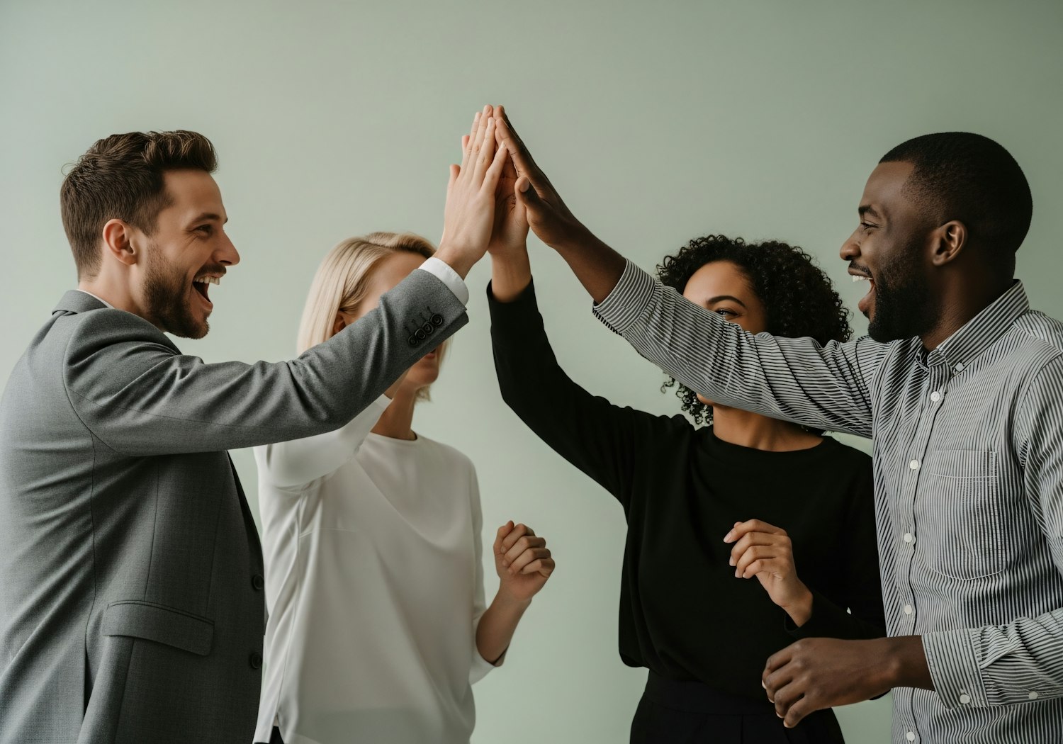 A diverse team of professionals celebrating a project milestone or small success together, reinforcing positive team dynamics and momentum.