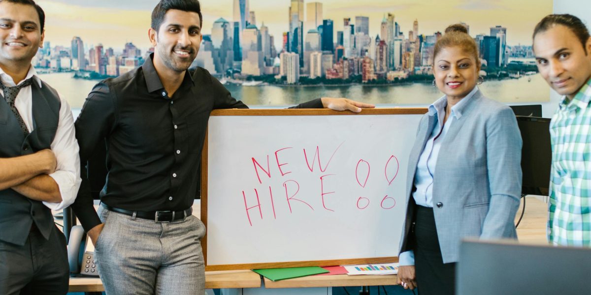 A new team member being warmly welcomed and introduced to their colleagues in an office setting.