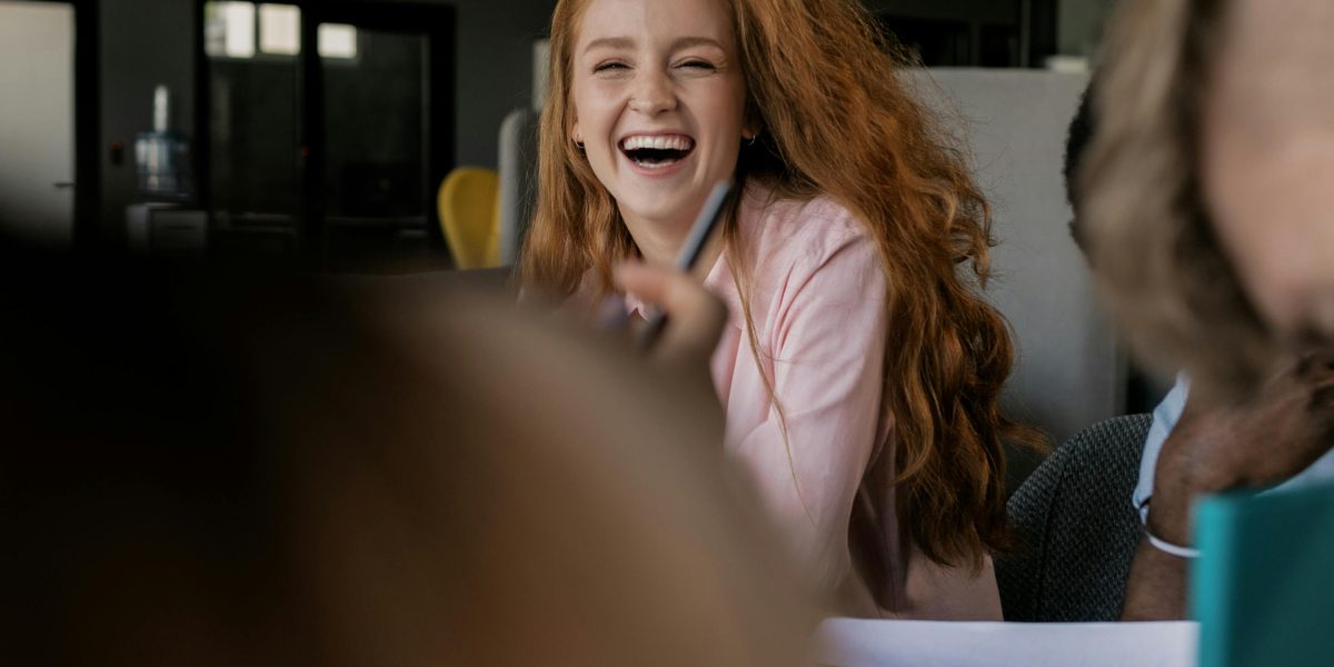 People engaging in a fun, low-stakes icebreaker activity, fostering laughter and comfort.