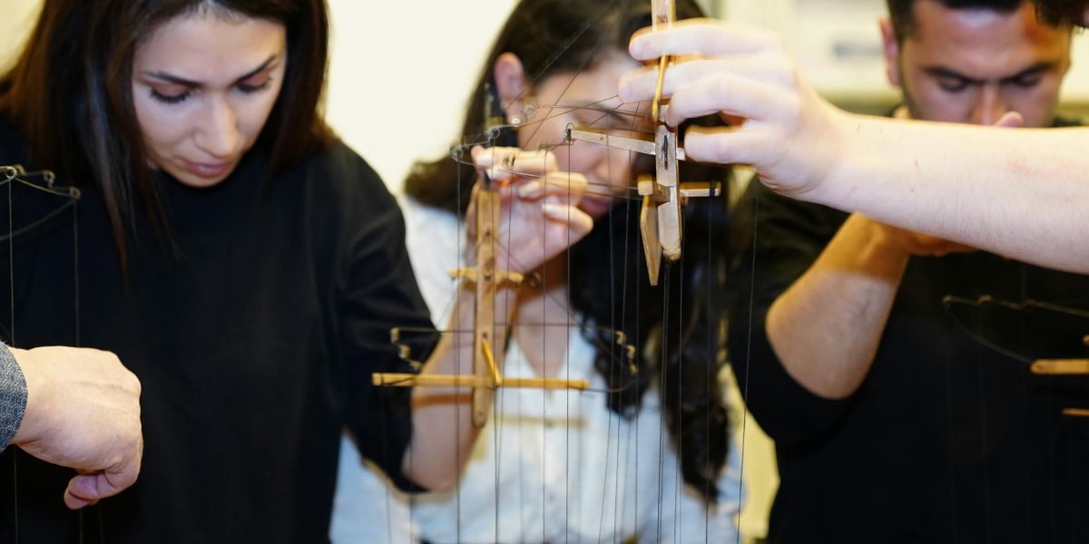 A group of professionals engaged in an interactive workshop, participating in a hands-on exercise or role-play scenario.