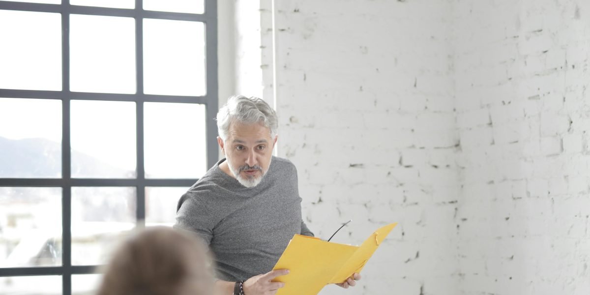 A facilitator actively guiding a team discussion, ensuring engagement and focused collaboration during a session.
